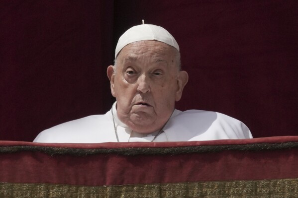 Pope Francis appears on the central lodge of St. Peter's Basilica to bestow the Urbi et Orbi (Latin for to the city and the world) blessing at the end of the Easter mass in St. Peter's Square at the Vatican Sunday, April 20, 2025. (AP Photo/Andrew Medichini)